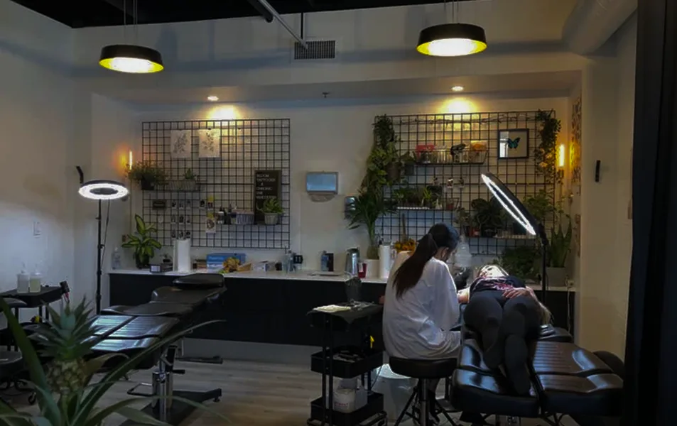 Chronic Ink tattoo studio interior with artist at work.