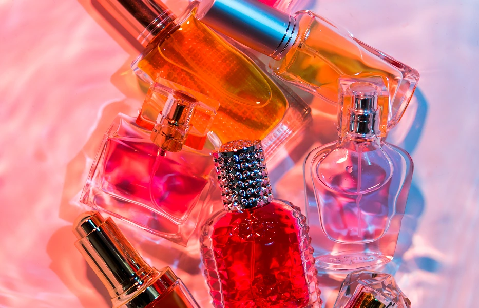 Fragrance Buy perfume bottles arranged in a vibrant editorial composition.