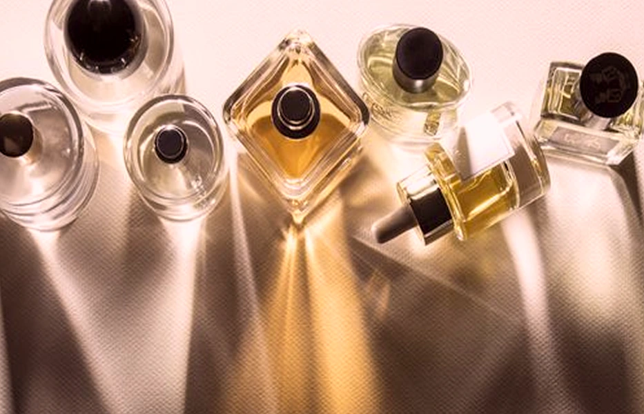 Fragrance Buy perfume bottles photographed in a warm editorial layout.